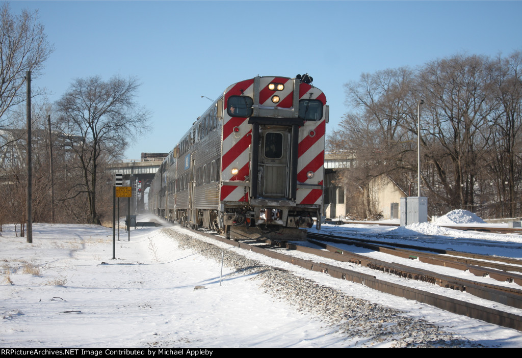 Metra cab car on the move.